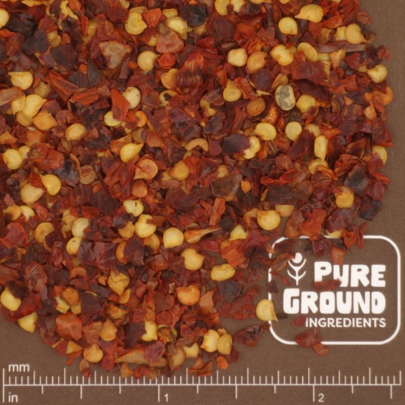 Chili Flakes with visible brand logo on a brown background