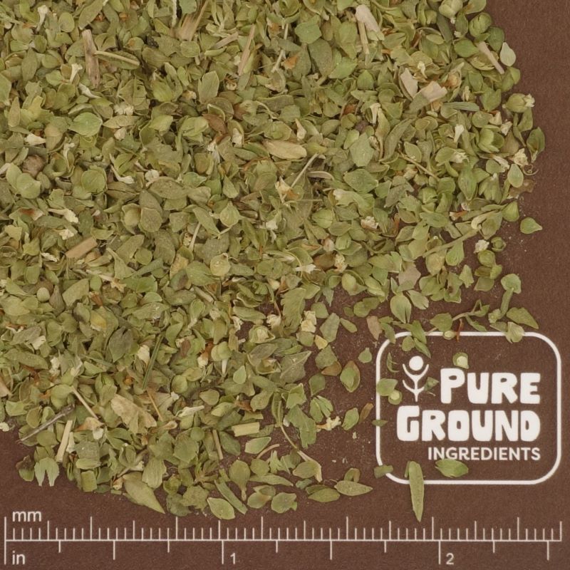 Dry green oregano herb on a brown background with 'Pure Ground Ingredients' label