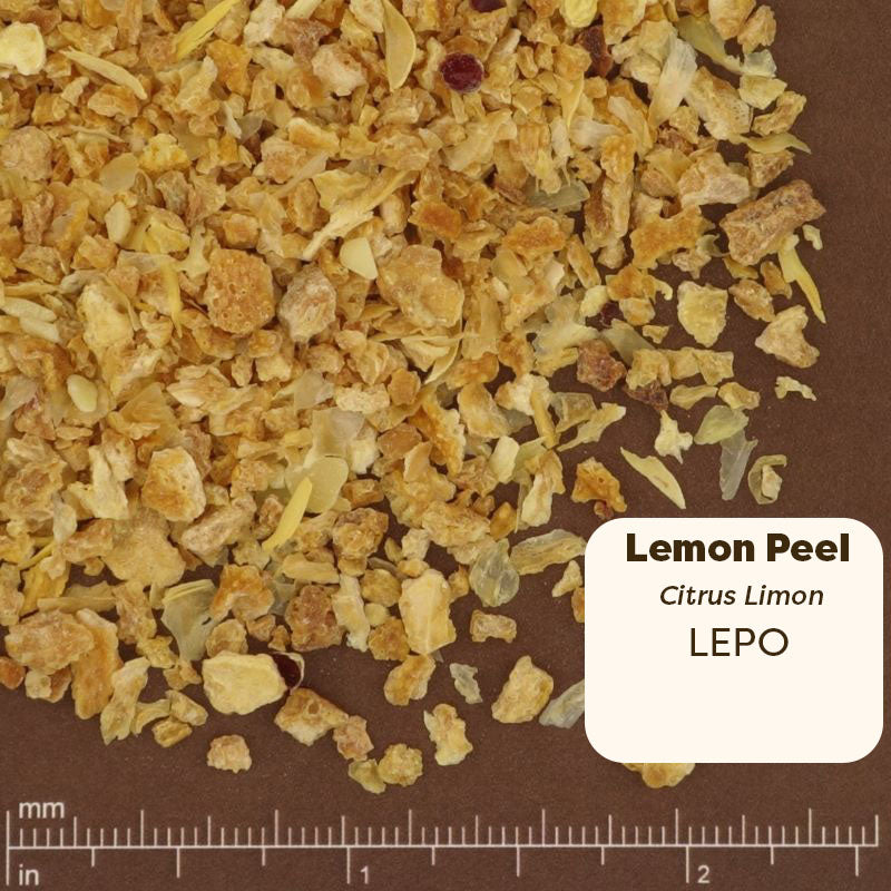 Dried lemon peel with a label indicating 'Lemon Peel' and 'LEPO' on a brown background. Scientific Name: Citrus Limon